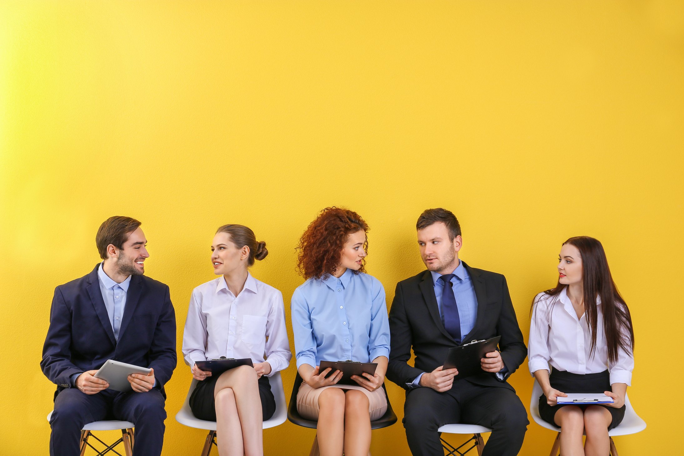 People Waiting for Job Interview on Yellow Wall Background